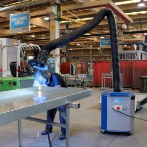 Operario soldando con aspiración localizada de humos mediante unidad móvil CleanGo con brazo flexible